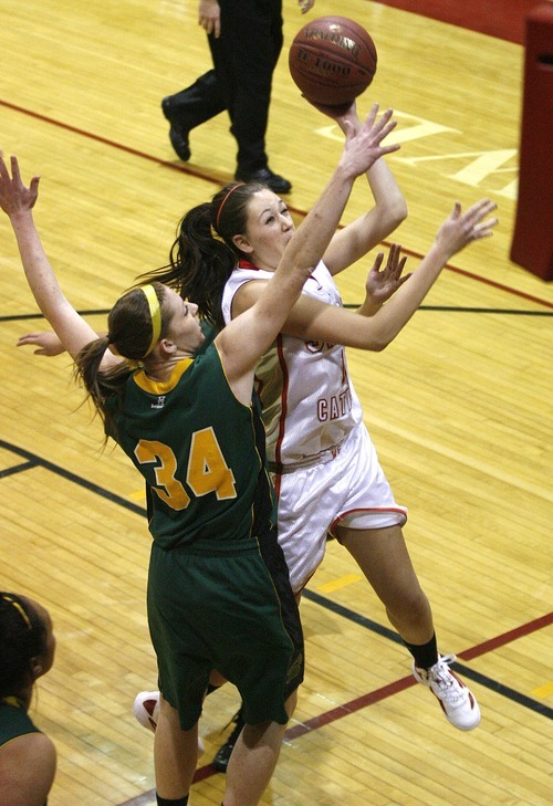 Paul Fraughton | The Salt Lake Tribune
Judge High's Donna Sansone  shoots the ball over the outstretched arms of Kearns' Micaelee Orton. Kearns High School girls team played Judge Memorial girls at Judge.
  Monday, December 19, 2011