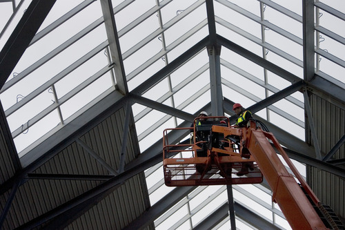 Kim Raff |  The Salt Lake Tribune

Outdoors store Scheels store leader, Karen Jones, puts the last bolt in the exterior steel structure completing the steel framework for the store in Sandy on Wednesday. The store uses 4 million pounds of structural steel and the store is expected to open in Oct. 6, 2012.