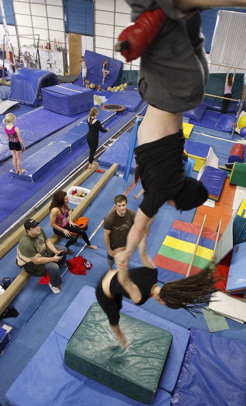 Trent Nelson  |  The Salt Lake Tribune
Trevor Ramboz and Charlee Shae perform on the trapeze. Tyce Nielsen spots the pair from below. Cirque de la Soul, an aerial and acrobatic troupe comprised of performers from the now-shuttered Mayan restaurant, is trying to keep its act going. The troupe practiced over the weekend at Hunt's Gymnastics Academy in Midvale.