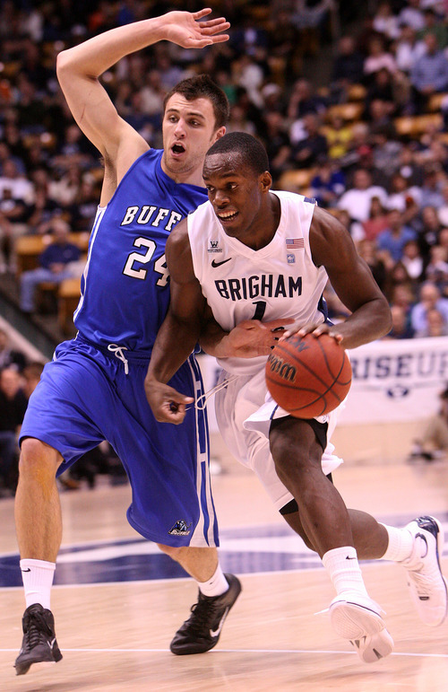 Leah Hogsten | The Salt Lake Tribune  
BYU guard Charles Abouo rounds Buffalo's Dave Barnett. Brigham Young University Cougars men's basketball team leads the Buffalo Bulls  47-39 in the first half Tuesday, December 20, 2011 at the Marriott Center.