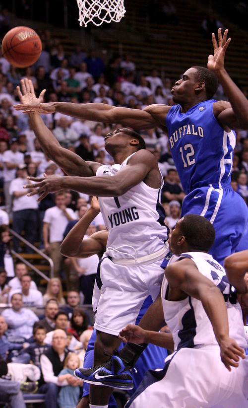 Leah Hogsten | The Salt Lake Tribune  
BYU guard Charles Abouo is fouled by Buffalo's Javon McCrea. Brigham Young University Cougars men's basketball team leads the Buffalo Bulls  47-39 in the first half Tuesday, December 20, 2011 at the Marriott Center.