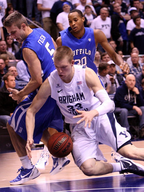 Leah Hogsten | The Salt Lake Tribune  
BYU forward Nate Austin (33)  hits the floor fighting for a lose ball. Brigham Young University Cougars men's basketball team leads the Buffalo Bulls  47-39 in the first half Tuesday, December 20, 2011 at the Marriott Center.