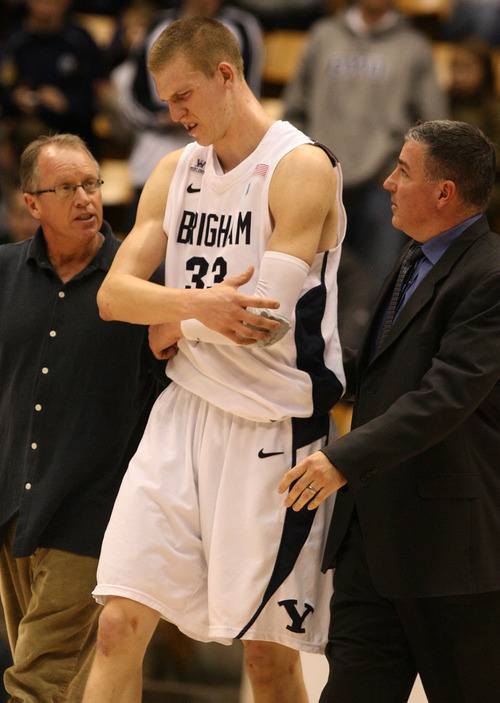 Leah Hogsten | The Salt Lake Tribune  
BYU forward Nate Austin (33) injures his left elbow late in the second half. Brigham Young University Cougars men's basketball team defeated the Buffalo Bulls  93-78 Tuesday, December 20, 2011 at the Marriott Center.