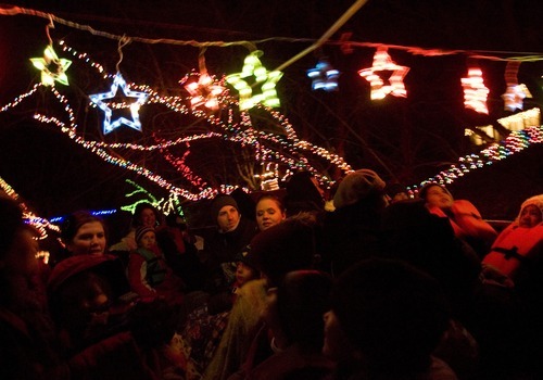 Kim Raff I The Salt Lake Tribune
Passengers on the Provo River Christmas Cruise look at Christmas lights on the Provo River on Thursday.