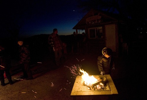 Kim Raff  I  The Salt Lake Tribune
Konrad Taotua stands by a fire pit while waiting for his trip on the Provo River Christmas Cruise in Provo on Thursday.