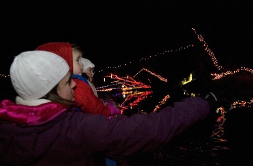 Kim Raff  I  The Salt Lake Tribune
Andrea Carlson, left, looks at Christmas lights with her two daughters Eden and Autumn Carlson during the Provo River Christmas Cruise on Thursday.