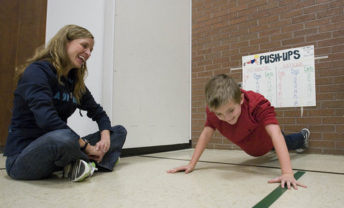 Paul Fraughton | The Salt Lake Tribune
Brady Anderson does push-ups  for  the President's Challenge fitness test, as parent volunteer Annie Cheney keeps count. Brady is a student at Park Lane Elementary School in Sandy, which has won the challenge 15 times for schools its size.
  Friday, December 16, 2011