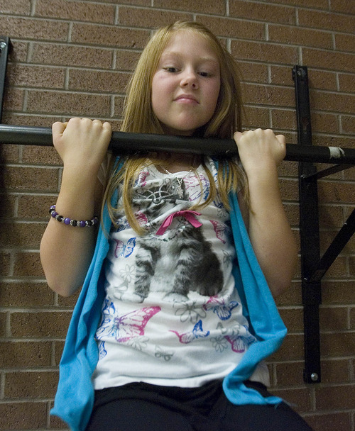 Paul Fraughton | The Salt Lake Tribune
Sarah McEuen, a third-grader at Park Lane Elementary School in Sandy, does pull-ups  for  the President's Challenge fitness test. 
  Friday, December 16, 2011