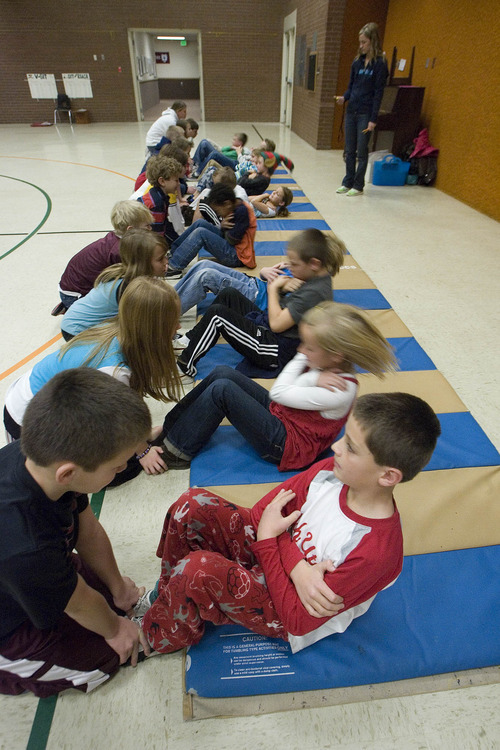 Paul Fraughton | The Salt Lake Tribune
Braden Cheney, a fourth-grader at Park Lane Elementary School in Sandy, joins third-graders at the school in the President's Challenge fitness test.  The group did as many sit-ups as they could in one minute.
  Friday, December 16, 2011