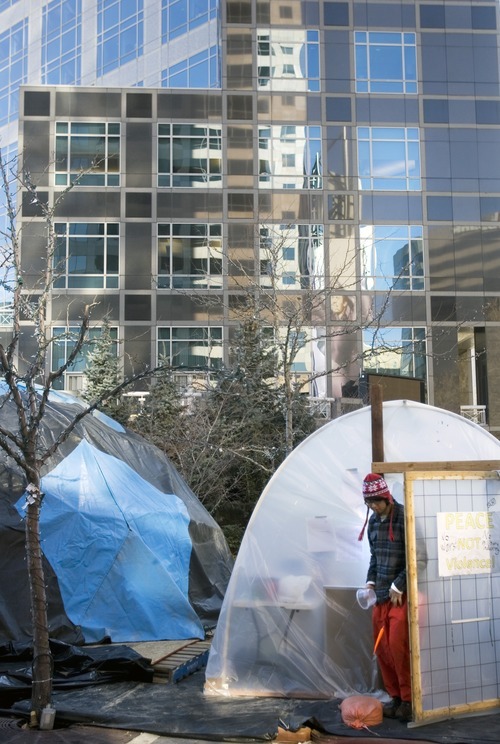 Kim Raff I The Salt Lake Tribune
Occupy SLC protester Carlos Trevino walks out of a temporary shelter at the Gallivan Center camp in Salt Lake City,  Dec. 25, 2011.