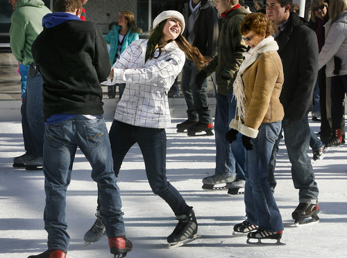 Scott Sommerdorf  |  The Salt Lake Tribune             
Kailie Quinn, center, skating with her boyfriend Braden Pelly, spins and looks back at her grandmother, Rosie Quinn, right. The Quinn family has been coming to the Gallivan ice rink on Christmas Eve for about 20 years. Saturday, December 24, 2011.