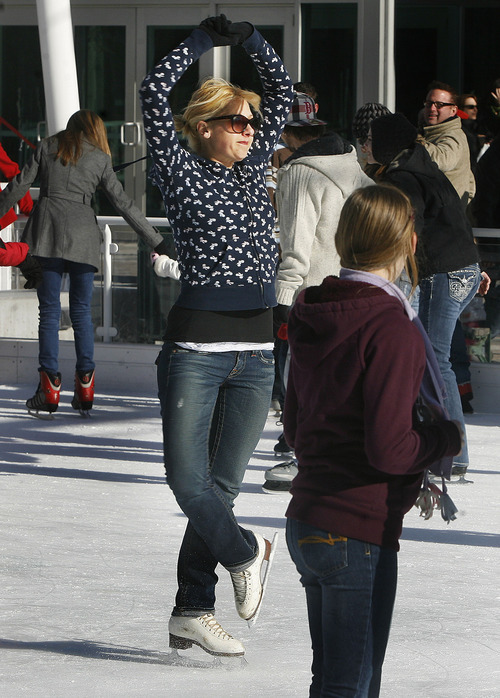 Scott Sommerdorf  |  The Salt Lake Tribune             
Rachel Low spins near center-ice as other ice skaters enjoy the ice at the new Gallivan Center ice rink, Saturday, December 24, 2011.