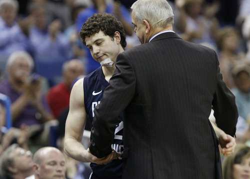 Scott Sommerdorf  |  The Salt Lake Tribune
BYU guard Jimmer Fredette (32) and head coach Dave Rose embrace  as Fredette comes out of the game with just seconds left. BYU lost 83-74 in OT to Florida at the New Orleans Arena in the 