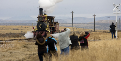 Al Hartmann  |  The Salt Lake Tribune
Photographers gather for a picture of Union Pacific steam locomotive 199 as it rolls down the track to the Golden Spike National Historic Site visitor center in northwestern Utah on Wednesday, Dec. 28, 2011. Golden Spike holds its annual Winter Steam Festival on December 28-30 Folks can get up close to tour the locomotive cab, see steam demonstrations as well as take a ride on a muscle powered handcart.