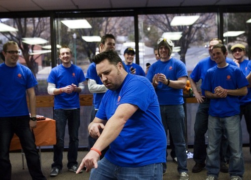 Kim Raff  I  The Salt Lake Tribune
Fishbowl employee Trent Devey dances Thursday as the Orem company celebrates paying off its $1 million loan from Zions Bank. The money was used to fund an employee buyout of the software company years earlier than expected.