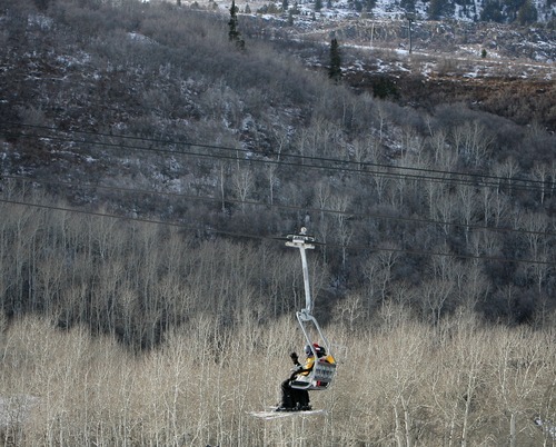 Steve Griffin  |  The Salt Lake Tribune
A record dry December means plenty of terrain is exposed as skiers ride a chairlift at Park City Mountain Resort on Thursday. Last year's snow season broke records, with many areas getting 300 to 400 percent of normal precipitation and culminating with a final day of skiing on July 4 at Snowbird.