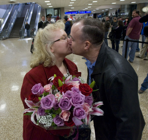 Al Hartmann  |  The Salt Lake Tribune
Hill Air Force Base Sgt. Margaret Williams, now dressed in civilian clothes, gets a kiss from her husband, Randall Williams, at the Salt Lake Airport on Wednesday, Dec. 21. She was among a group of seven Utah airmen from Hill Air Force Base who departed from the last Air Force C17 from Ali Air Base in Iraq on Saturday.