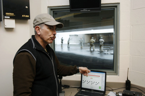 Francisco Kjolseth  |  The Salt Lake Tribune
Troops train in firearms at the flat range of the Farr West Swanson Tactical Training Center as Randy Watt, a recently retired Ogden assistant police chief who has been a top military adviser in Iraq, talks about the facilities from the control room. He's a colonel in the Utah National Guard, and commanding officer of the 19th Special Forces Group.