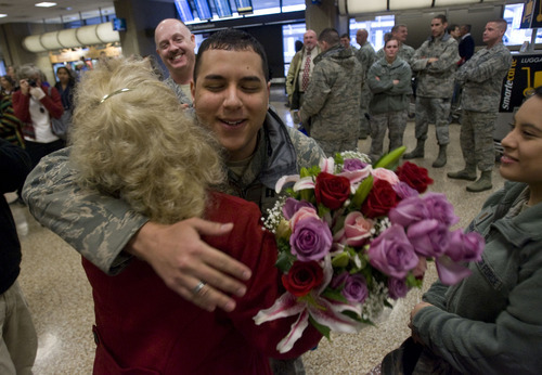 Al Hartmann  |  The Salt Lake Tribune
Hill Air Force Base Captain William Figueroa hugs Sgt. Margaret Williams now dressed in civilian clothes at the  Salt Lake Airport Wednesday morning December 21.  She was among a group of seven Utah airmen from Hill Air Force base who departed from the last Air Force C17 from  Ali Air base in Iraq on Saturday.