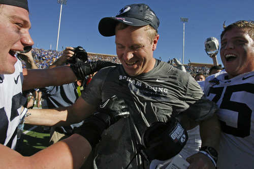Rick Egan  | The Salt Lake Tribune 

Brigham Young Cougars head coach Bronco Mendenhall smiles after getting  drenched with Powerade as BYU celebrates their 24-21 win over Tulsa in the Armed Forces Bowl, in Dallas, Texas, Friday, December 30, 2011