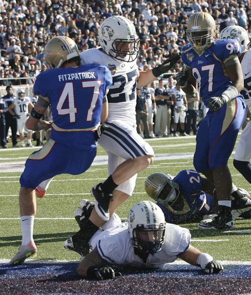 Rick Egan  | The Salt Lake Tribune 


Tulsa Golden Hurricane punter Kevin Fitzpatrick (47) is bumped by David Foote (27) and Kyle Van Noy (3) in the end zone,  which gave the Golden Hurricanes a first down, Friday, December 30, 2011