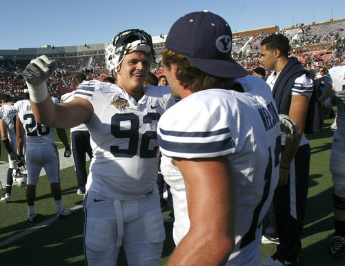 Rick Egan  | The Salt Lake Tribune 

Brigham Young Cougars defensive end Graham Rowley (92) hugs Riley Nelson (13) as they celebrate the 24-21 win over Tulsa in the Armed Forces Bowl, in Dallas, Texas, Friday, December 30, 2011