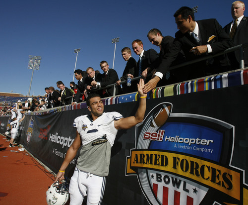 Rick Egan  | The Salt Lake Tribune 

BYU linebacker Kyle Van Noy (3) high-fives LDS missionaries from the Dallas Texas Mission, as theycelebrate the 24-21 win over Tulsa in the Armed Forces Bowl, in Dallas, Texas, Friday, December 30, 2011