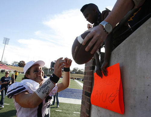 Rick Egan  | The Salt Lake Tribune 

Brigham Young Cougars quarterback Riley Nelson (13) was the last player on the field signing autographs after BYU's 24-21 win over Tulsa in the Armed Forces Bowl, in Dallas, Texas, Friday, December 30, 2011