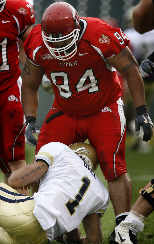 Trent Nelson | The Salt Lake Tribune

Utah's Steve Fifita stands over Georgia Tech QB Reggie Ball after sacking him on a fourth down play, during the 1st half of the Emerald Bowl in San Francisco on December 29, 2005.