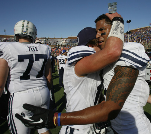 Rick Egan  | The Salt Lake Tribune 

Riley Nelson (13) hugs Wide receiver Cody Hoffman (2) as they celebrates the Cougars 24-21 win over Tulsa in the Armed Forces Bowl, in Dallas, Texas, Friday, December 30, 2011