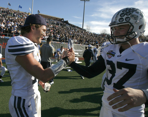Rick Egan  | The Salt Lake Tribune 

Brigham Young Cougars quarterback Riley Nelson (13) and kicker Justin Sorensen (37) as time runs out, in football action, BYU vs. Tulsa, in the Armed Forces Bowl, in Dallas, Texas, Friday, December 30, 2011