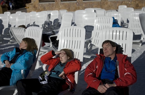 Kim Raff I The Salt Lake Tribune
(from left) Cindy, Isabel, and Bob Holland nap in the sun ouside of the Silver Lake Lodge at Deer Valley Resort in Park City, Utah on January 1, 2012.