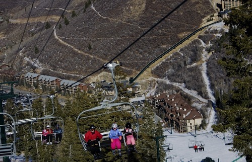 Kim Raff  I  The Salt Lake Tribune
Skiers ride the Silver Lake Express with the snowless valley in the background at Deer Valley Resort in Park City on Sunday.