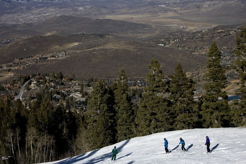 Kim Raff I The Salt Lake Tribune
Skiers ride down the Rosebud trail with a snowless valley in the background at Deer Valley Resort in Park City, Utah on January 1, 2012.