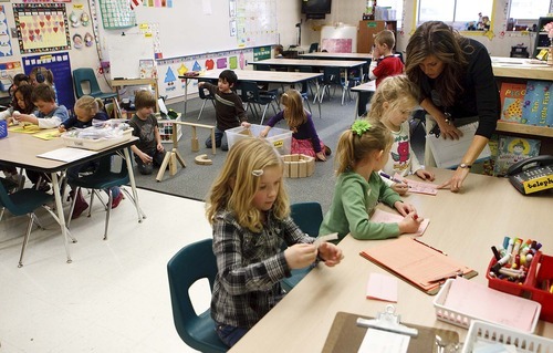 Trent Nelson  |  Tribune file photo
Kindergarten teacher Pam Saltmarsh helps a student in her classroom at Oak Hollow Elementary in Draper in February.