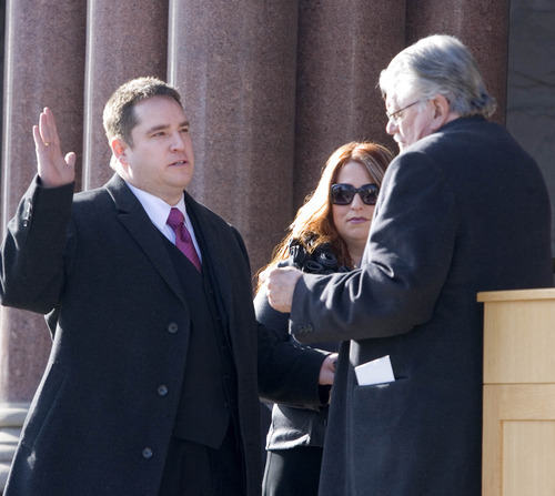 Paul Fraughton | The Salt Lake Tribune.
Charles Fox Luke, standing next to his wife Karen, is sworn in as City Council District 6 councilman by Judge Bruce Jenkins at a ceremony Tuesday, Jan. 3, 2012, on the steps of Salt Lake City Hall.