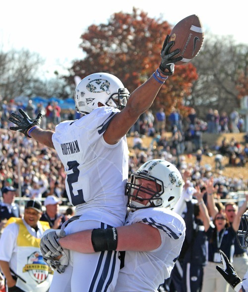 Rick Egan  | The Salt Lake Tribune 

Brigham Young Cougars offensive lineman Braden Hansen (76 lifts )Wide receiver Cody Hoffman (2) as they celebrate the winning touchdown in the 24-21 win over Tulsa in the Armed Forces Bowl, in Dallas, Texas, Friday, December 30, 2011