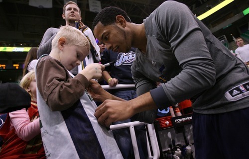 Steve Griffin  |  The Salt Lake Tribune

Utah Jazz guard Devin Harris signs a young fan's jersey following warm-up before game against the Bucks at EnergySolutions Arena in Salt Lake City, Utah  Tuesday, January 3, 2012.
