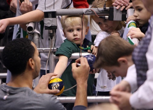 Steve Griffin  |  The Salt Lake Tribune

Utah Jazz guard Devin Harris signs mini basketballs for young fan's  following warm-up before game against the Bucks at EnergySolutions Arena in Salt Lake City, Utah  Tuesday, January 3, 2012.
