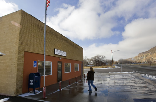 Al Hartmann  |  The Salt Lake Tribune
An Emery resident enters the town's post office, which could close. Residents who do business and receive medications through the mail would have to drive north to Ferron to collect their mail.