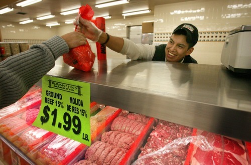 Steve Griffin  |  The Salt Lake Tribune
Avolfo Hernandez, a butcher at Rancho Markets on 3300 South and 900 East in Salt Lake City, hands meat to a customer Thursday.