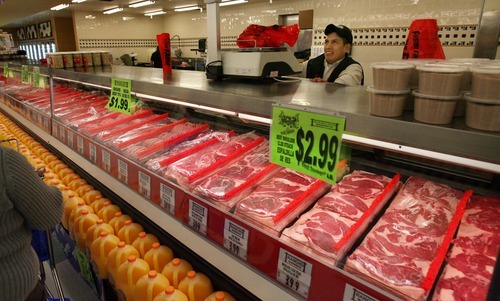 Steve Griffin  |  The Salt Lake Tribune
Avolfo Hernandez, a butcher at the new Rancho Markets store, weighs some meat for a customer on Thursday.