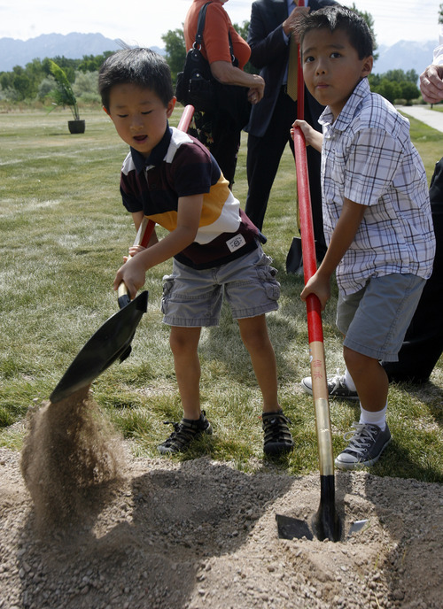 Rick Egan   |  Tribune file photo
Dillon Fang, 5, and his brother, Logan Fang, 7, of Bountiful, turn over a shovel of dirt at the groundbreaking ceremony for the Chinese Heritage Gate at the Utah Cultural Celebration Center in West Valley City on  July 26, 2011. The Chinese Heritage Gate commemorates the local Chinese community and the connection between West Valley City and Nantou, Taiwan.