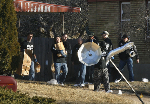 Scott Sommerdorf  |  The Salt Lake Tribune             
Police bring out various pieces of evidence from the home at 3268 Jackson St. in Ogden, Thursday, January 5, 2012. Five police officers were injured and one killed in a firefight during a drug raid Wednesday night.