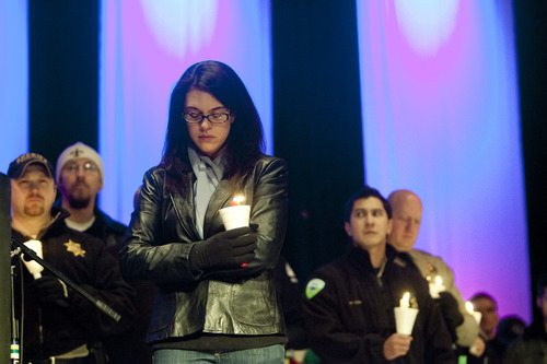 Kim Raff  |  The Salt Lake Tribune

Erin Francom widow of Agent Jared Francom, who was killed, and the five other officers who were wounded in a gun battle with a suspect the night before, attends a candle light vigil at the Ogden Amphitheater in Ogden on Jan. 5, 2012.