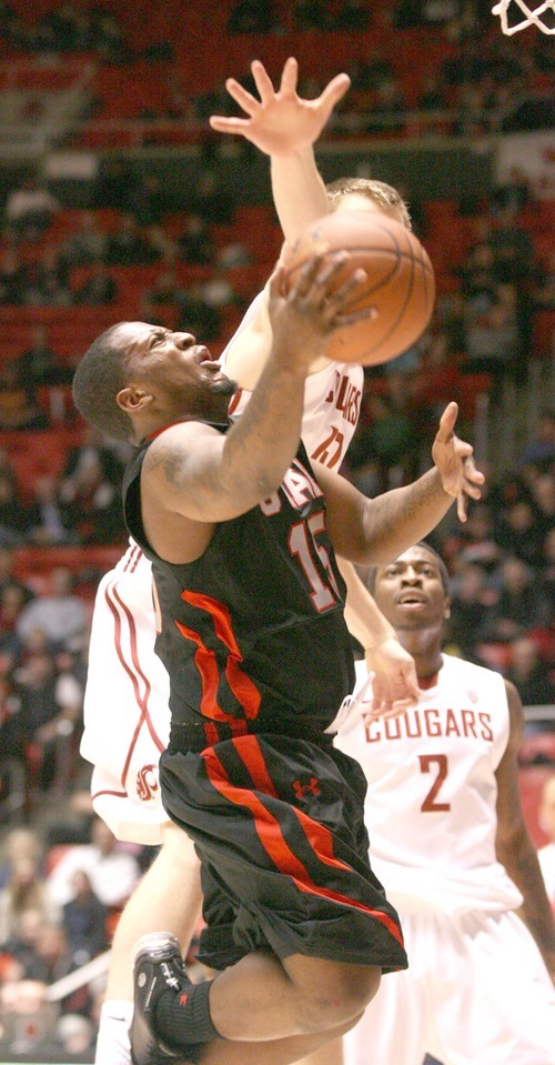 Paul Fraughton | The Salt Lake Tribune.
Utah's Josh Watkins grimaces as he shoots the ball.  He went down with an apparent injury on the play, but returned to lead the Utes in scoring.Utah played Washington State in the Huntsman Center.
 Thursday, January 5, 2012
