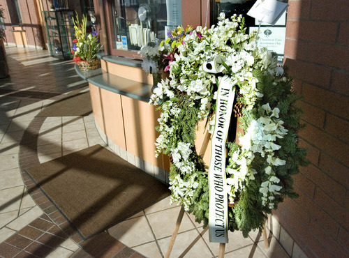Paul Fraughton | The Salt Lake Tribune.
A memorial wreath along with other flower arrangements  in the lobby of the Ogden City Police headquarters.
 Friday, January 6, 2012