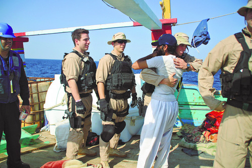 The Associated Press
In this Thursday photo released by the U.S. Navy, a U.S. sailor assigned to the guided-missile destroyer USS Kidd greets a crew member of the Iranian-flagged fishing dhow Al Molai, that had been commandeered by suspected Somali pirates.