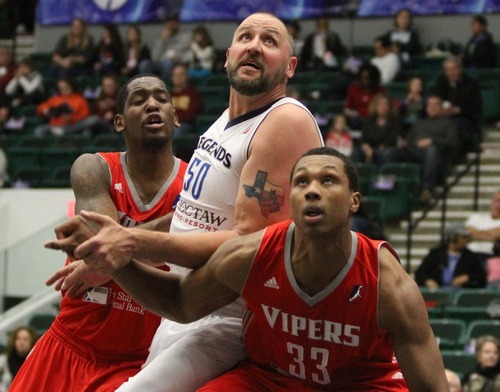 Rick Egan  | The Salt Lake Tribune 

Greg Ostertag (50) battles for position along with Vipers Suleiman Braimoh (24) and Greg Smith (33) in NBA D League action,  Texas Legends Vs. The Rio Grande Valley Vipers, at Dr Pepper Arena in Frisco, Texas, Thursday, December 29, 2011.