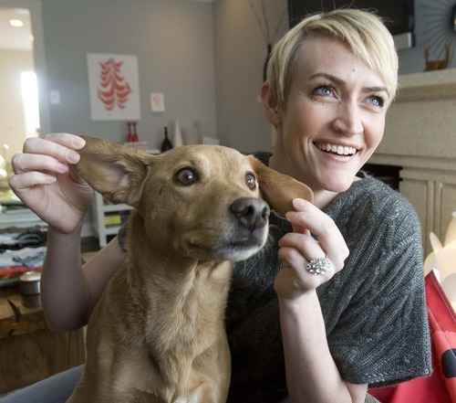 Paul Fraughton  |  Tribune file photo
Famed Utah mommy blogger Heather Armstrong plays with her dog Chuck in this file photo. A recent study shows that stay-at-home moms who blog are much happier due to an increased social network that keeps them connected.